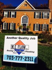 large house with M.E. Flow service sign